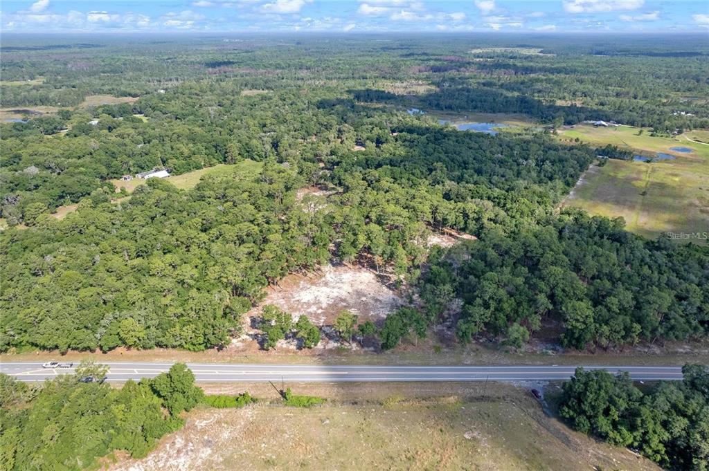 29901 State Road 44 Eustis, FL 32736 - Photo 11 of 24 an aerial view of residential houses with outdoor space and trees