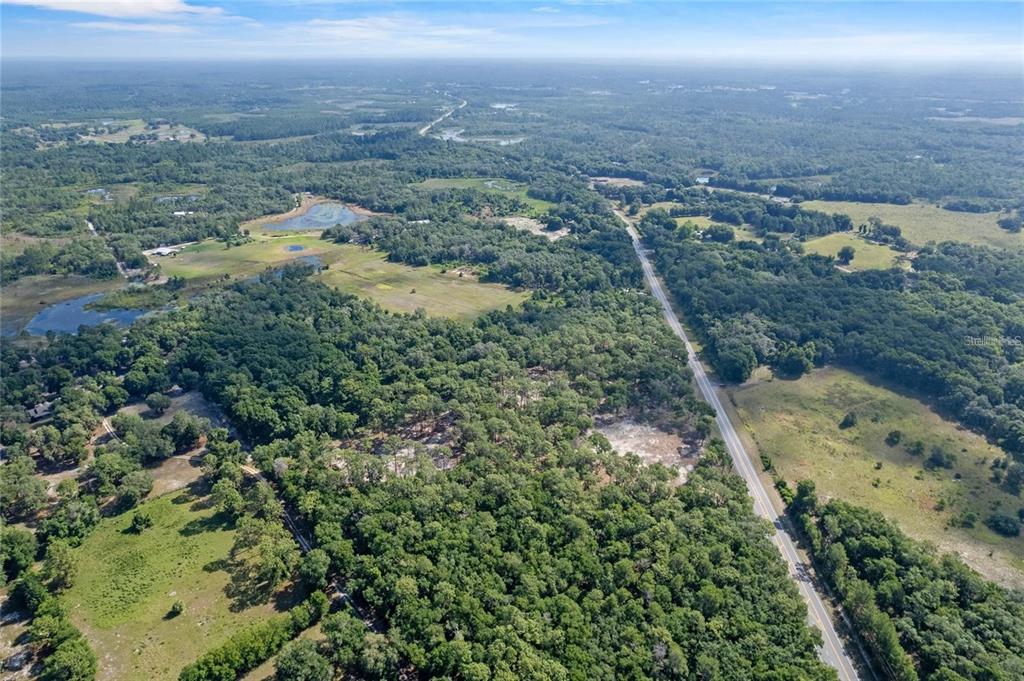 29901 State Road 44 Eustis, FL 32736 - Photo 20 of 24 an aerial view of a houses with a yard