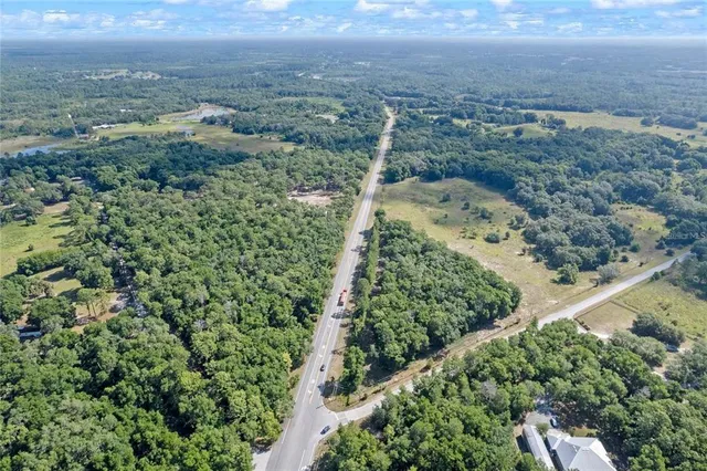 an aerial view of a houses with a yard