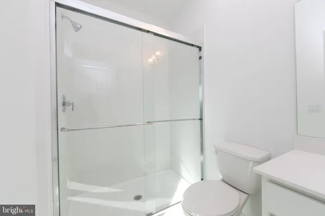a bathroom with a shower and a toilet
