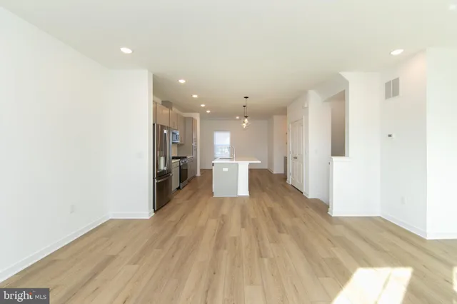 a view of a kitchen with wooden floor