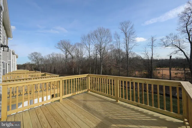 a view of balcony with wooden floor and fence