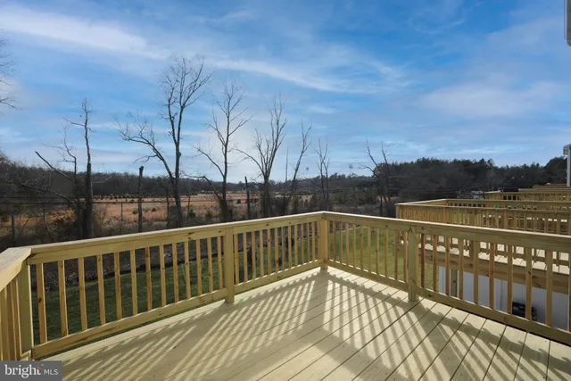 a view of balcony with wooden floor and fence