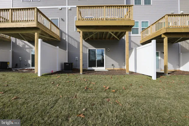 a view of a big room with lots of furniture and windows
