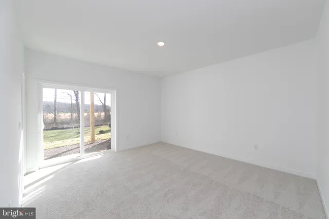 an empty room with glass door and windows
