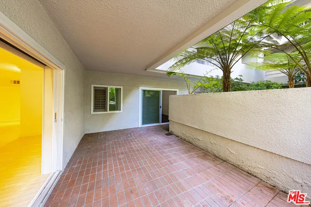 a view of a room with wooden floor and a yard