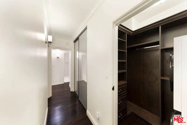 a view of hallway with wooden floor