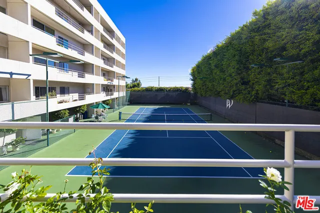 a view of swimming pool with a tennis court