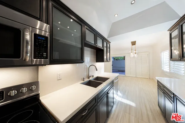 a kitchen with a sink and a stove top oven