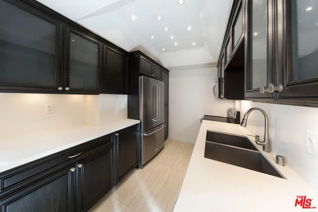 a kitchen with a sink and refrigerator