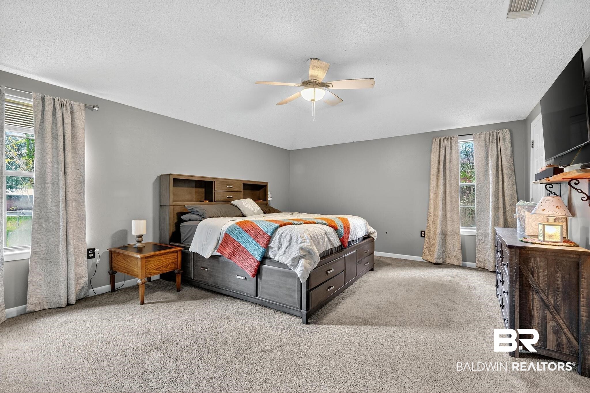 21895 2nd Street Silverhill, AL 36576 - Photo 30 of 43 Primary bedroom featuring carpet floors, ceiling fan, and two closets