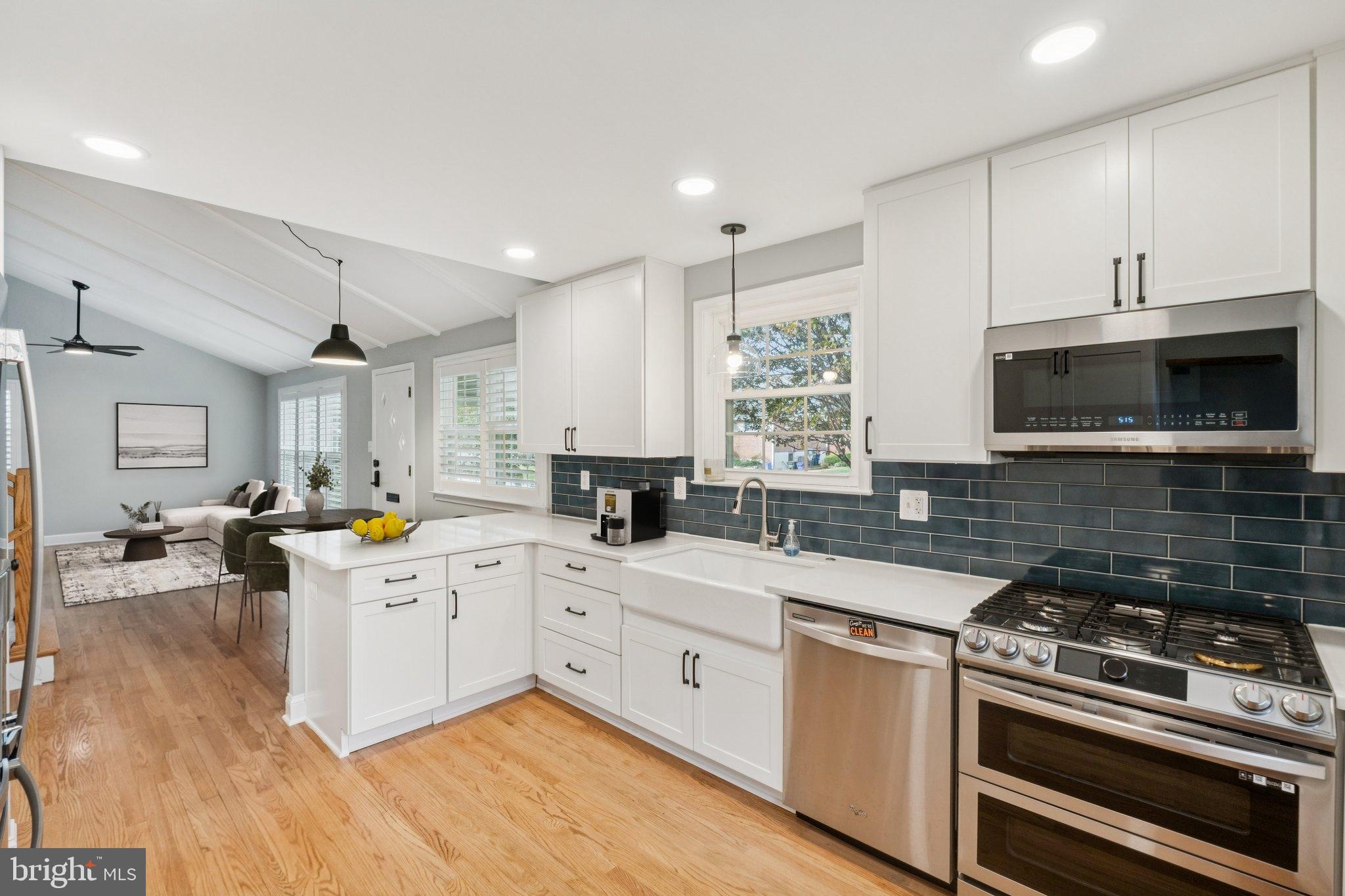 a kitchen with a stove sink and microwave