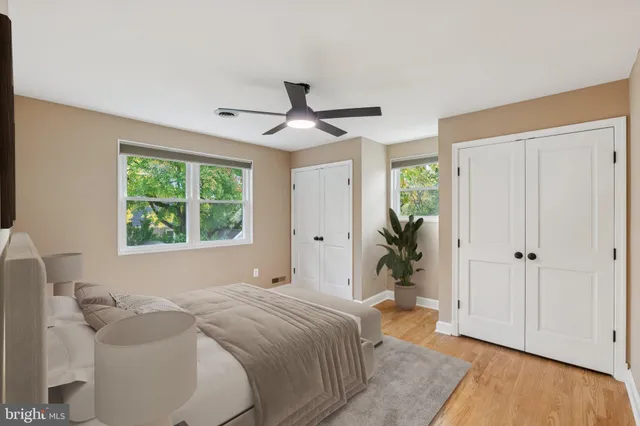 a bedroom with a bed and a large window