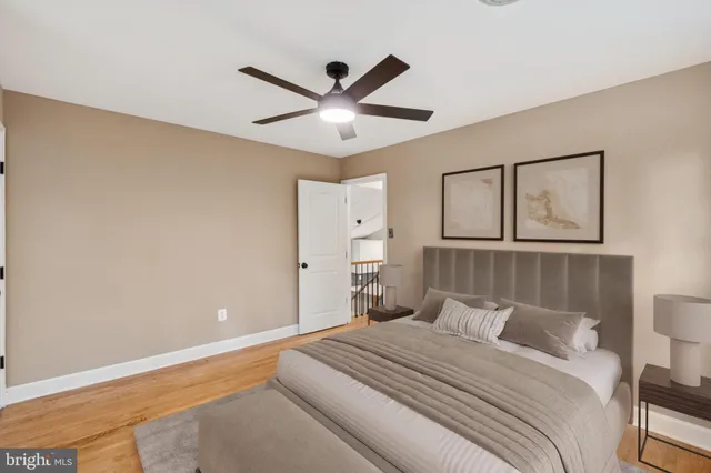 a bedroom with a large bed and a ceiling fan
