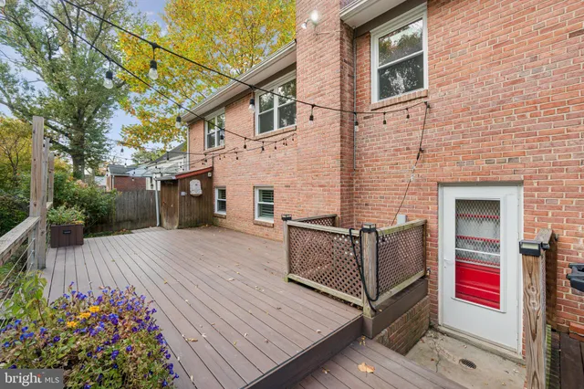 a view of house with outdoor seating and wooden floor