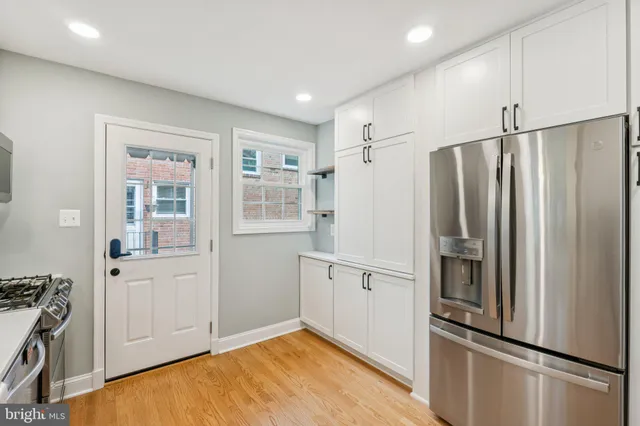 a kitchen with stainless steel appliances a refrigerator and cabinets