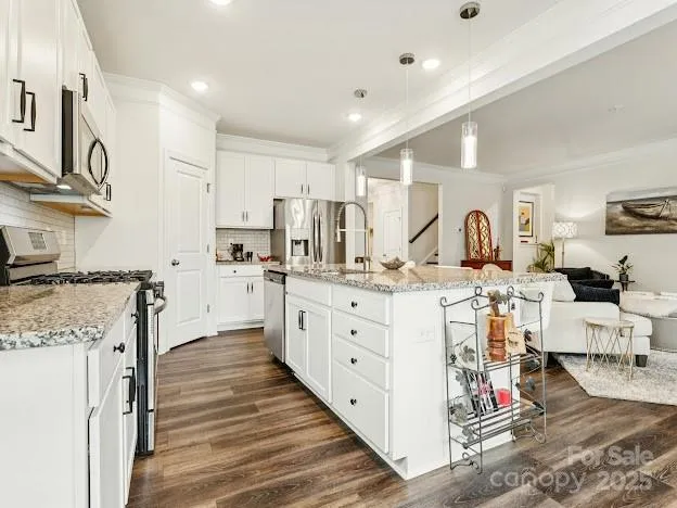 a large white kitchen with cabinets