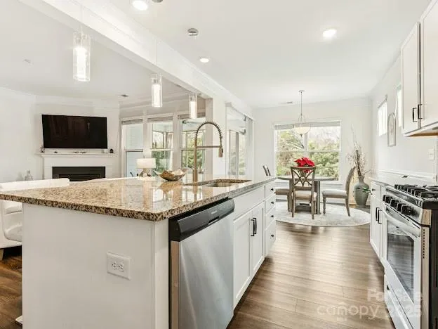 a kitchen with granite countertop a sink and appliances