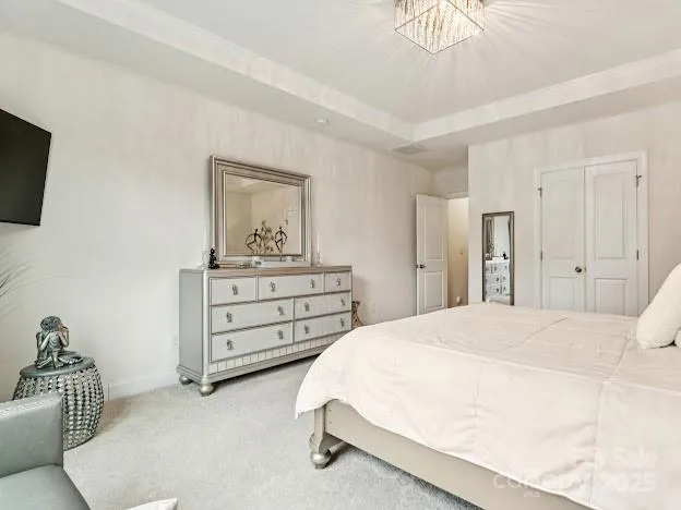 a spacious bedroom with a bed and a couch