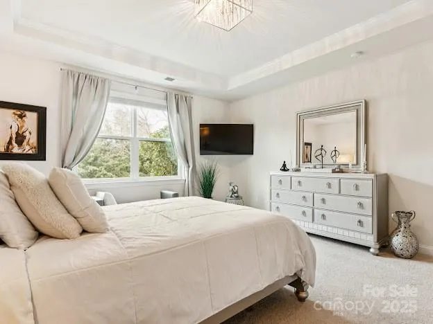 a bedroom with a bed a window and a television