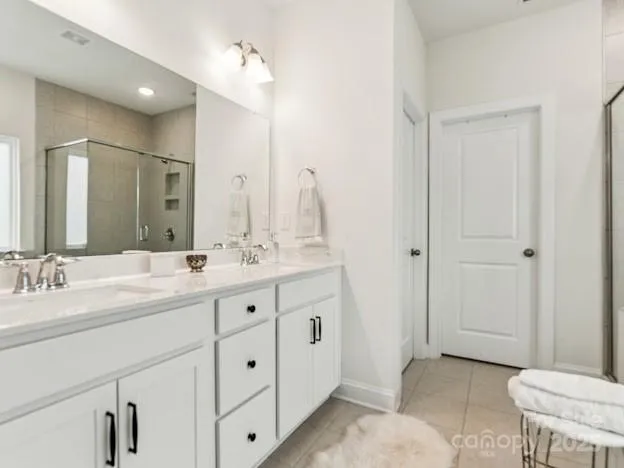 a bathroom with a double vanity sink a toilet and a mirror