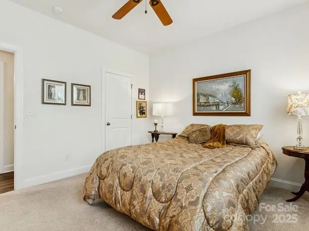 a bedroom with a bed and painting on the wall