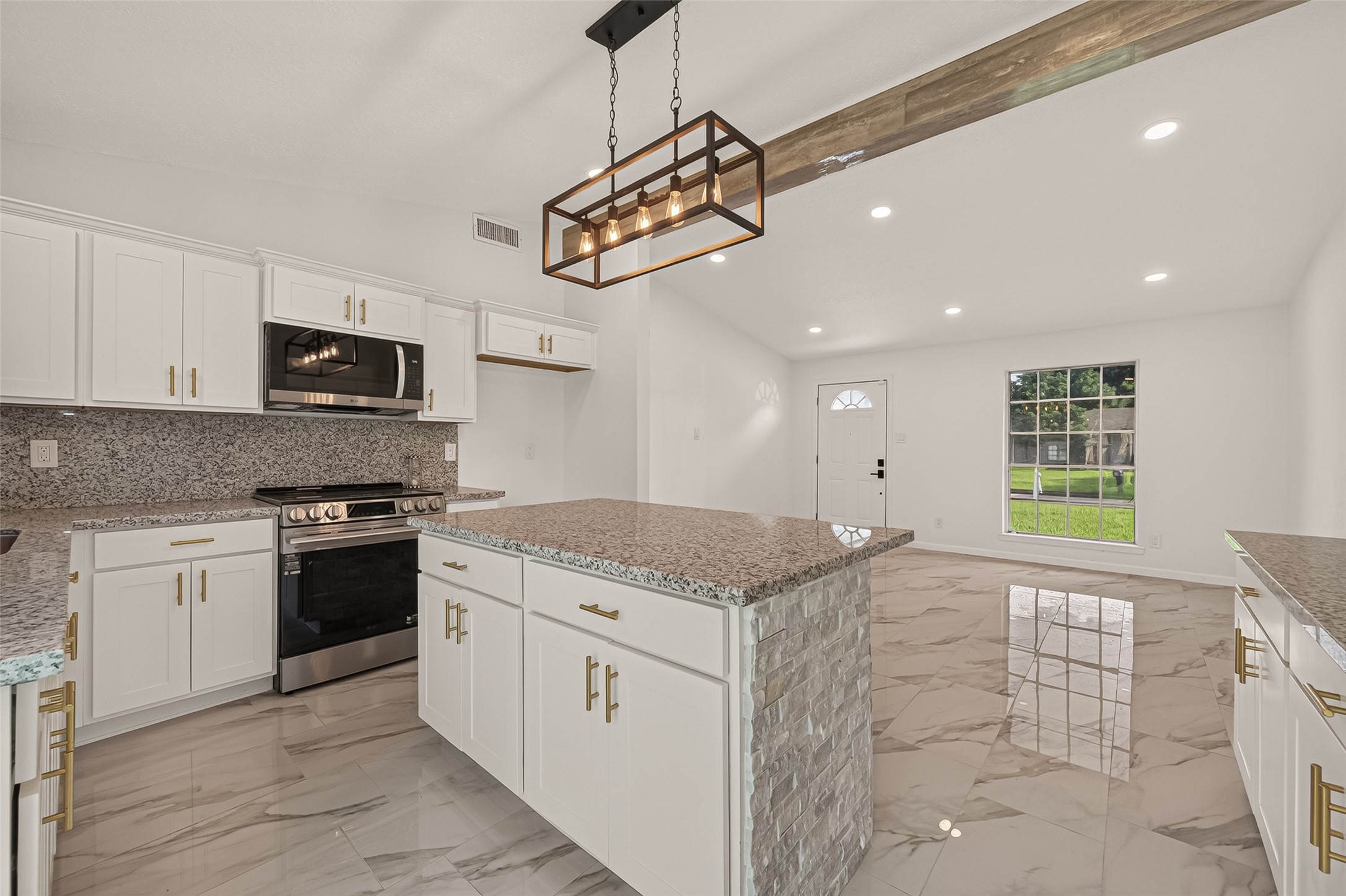 16619 Tibet Road Friendswood, TX 77546 - Photo 29 of 29 Bright, modern kitchen with granite countertops, stainless steel appliances, and sleek cabinetry. Features a large island, pendant lighting, and open floor plan with marble-style flooring.