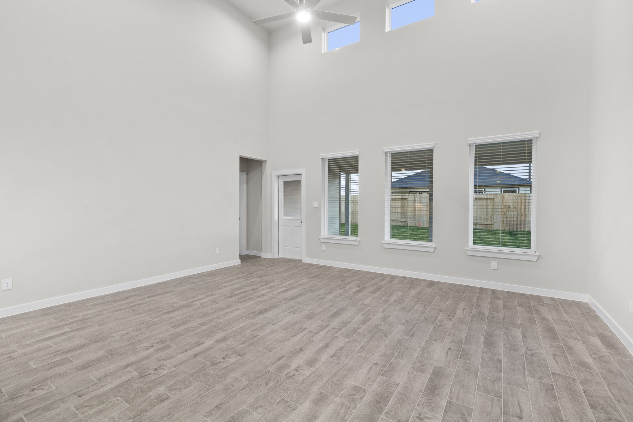 3015 Boulder Ridge Drive Rosenberg, TX 77471 - Photo 9 of 34 a view of an empty room with wooden floor and a window