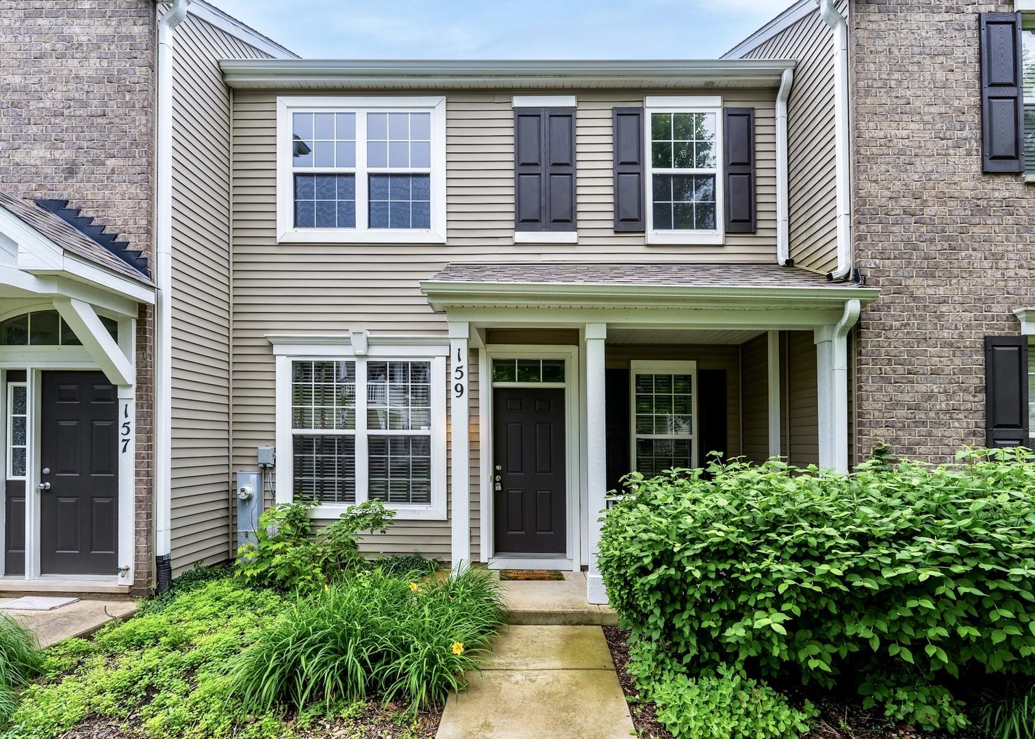 159 Springbrook Trail South Oswego, IL 60543 - Photo 1 of 32 front view of a brick house with a large windows
