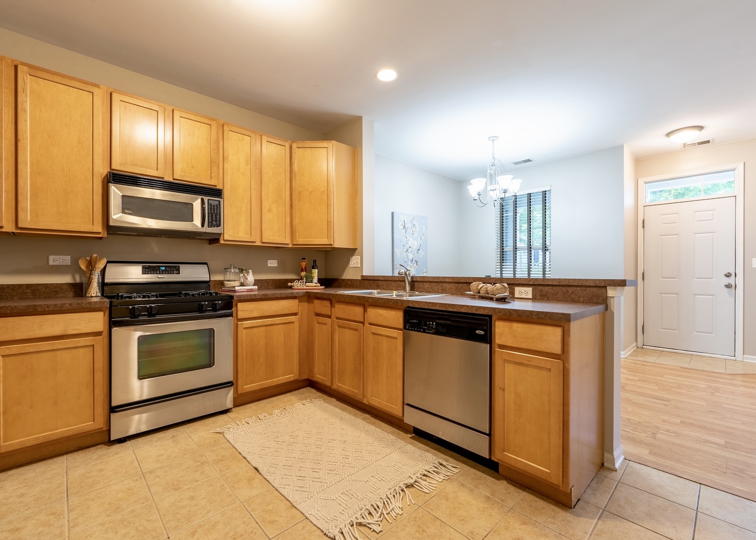159 Springbrook Trail South Oswego, IL 60543 - Photo 18 of 32 a kitchen with stainless steel appliances granite countertop a stove a sink and a microwave