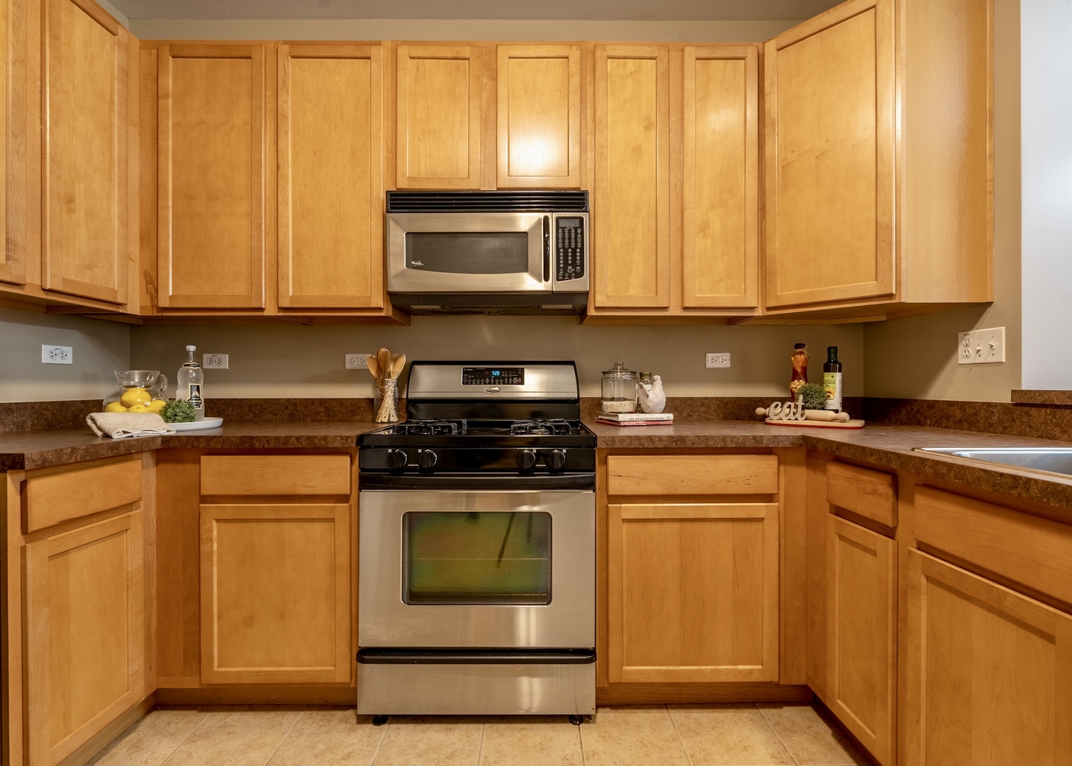 159 Springbrook Trail South Oswego, IL 60543 - Photo 20 of 32 a kitchen with a stove a sink and a microwave