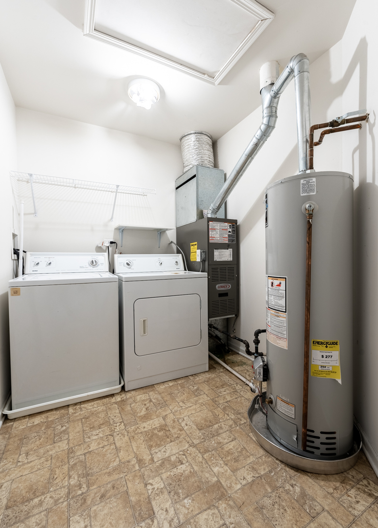 159 Springbrook Trail South Oswego, IL 60543 - Photo 25 of 32 a view of a storage & utility room with a washer and dryer