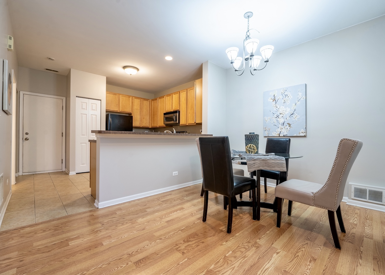159 Springbrook Trail South Oswego, IL 60543 - Photo 10 of 32 a view of a dining room with furniture a chandelier and wooden floor