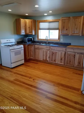 a kitchen with a refrigerator sink and cabinets