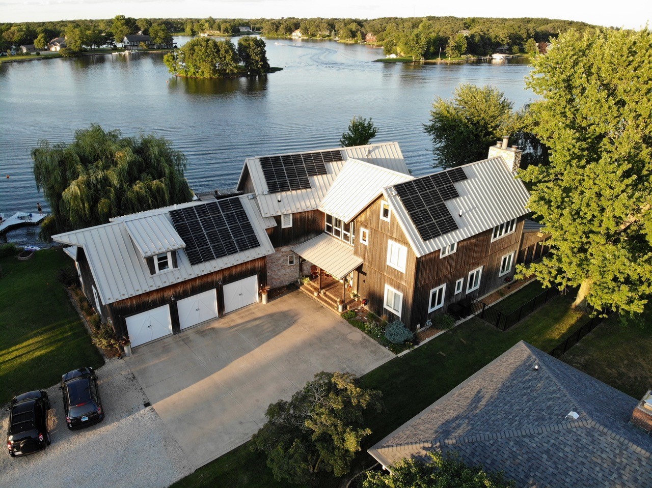 an aerial view of a house with outdoor space and lake view