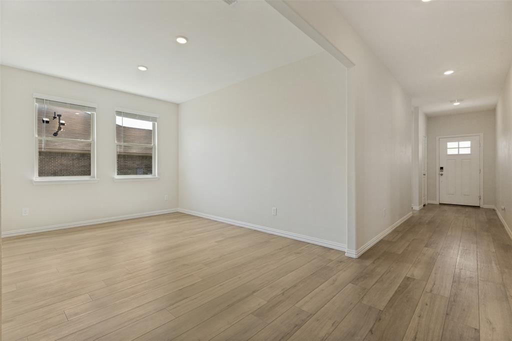 1237 Almond Road Azle, TX 76020 - Photo 3 of 24 an empty room with wooden floor and windows