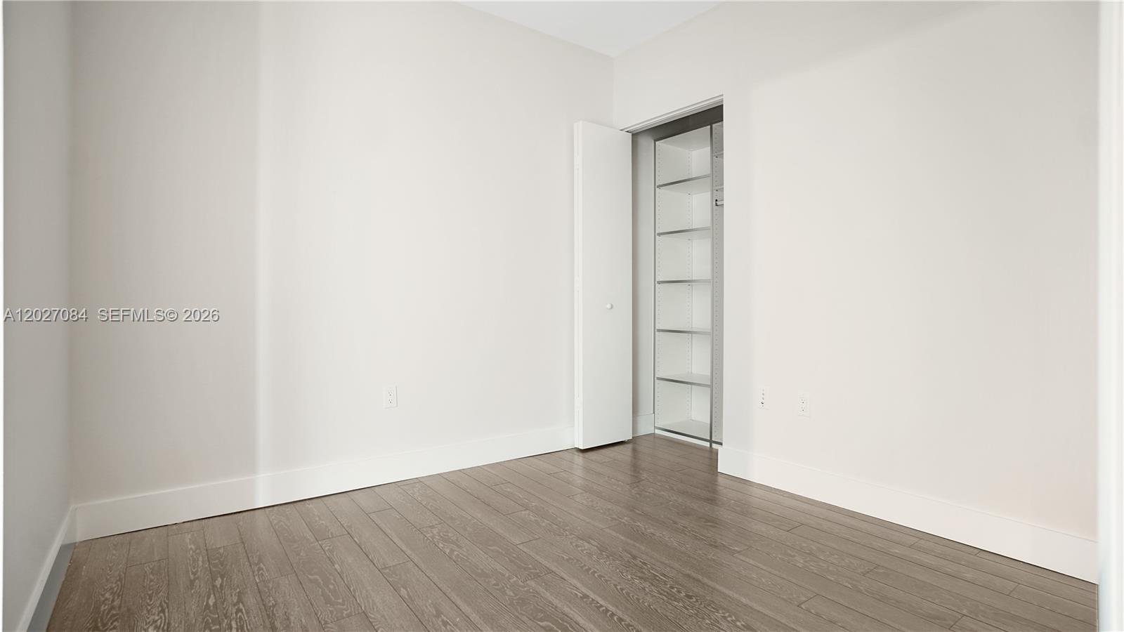 92 Southwest 3rd Street, Unit 1803 Miami, FL 33130 - Photo 14 of 29 a view of an empty room with wooden floor