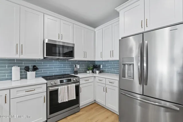 a bedroom with a bed a window and a flat screen tv