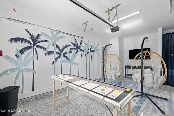 a dining room with wooden floor a chandelier a wooden table and chairs