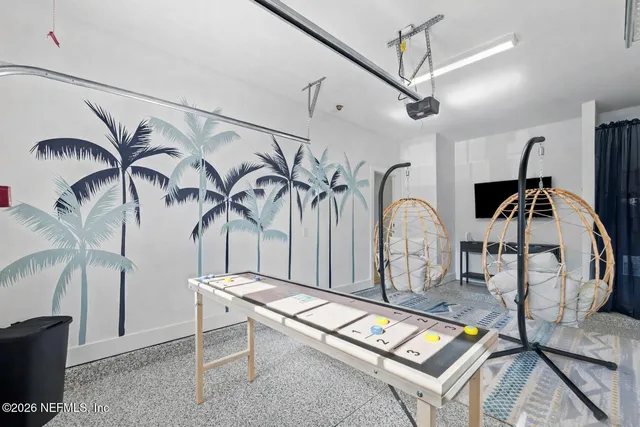 a dining room with wooden floor a chandelier a wooden table and chairs