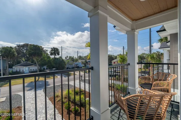 a view of a balcony with furniture and floor to ceiling window