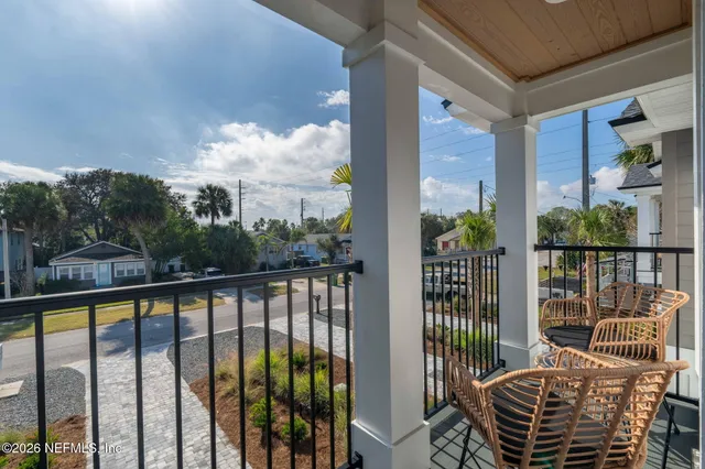a view of a balcony with furniture and floor to ceiling window