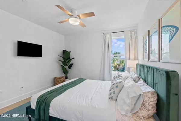 a bedroom with a large bed and a large window