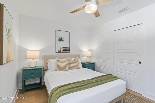 a bedroom with a bed and a chandelier