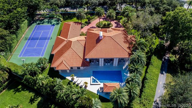 an aerial view of a house with a yard basket ball court and outdoor seating