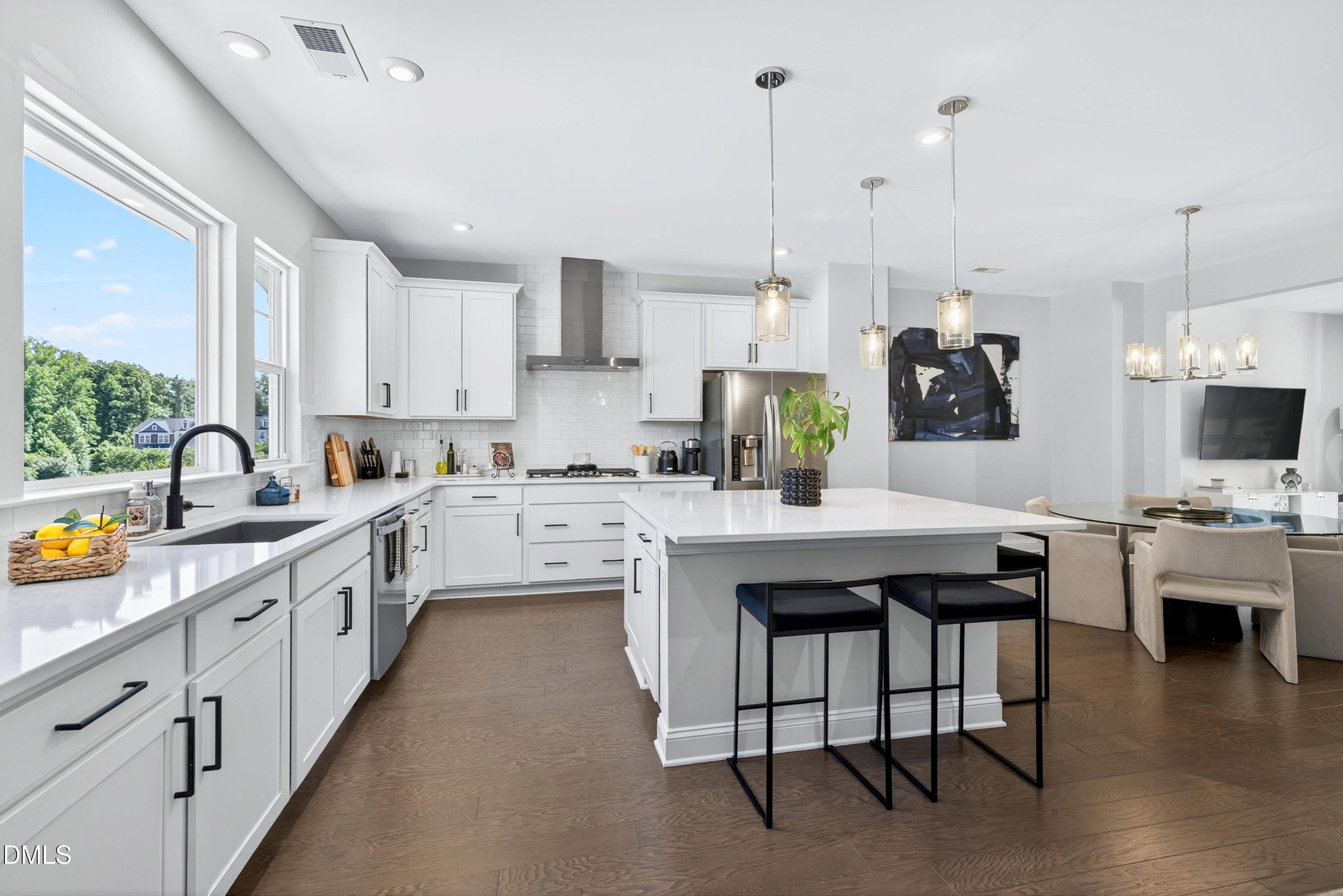 1063 Danvers Loop Apex, NC 27523 - Photo 24 of 67 a large kitchen with stainless steel appliances kitchen island granite countertop a large island in the center