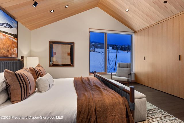 a bathroom with a double vanity sink a mirror and shower