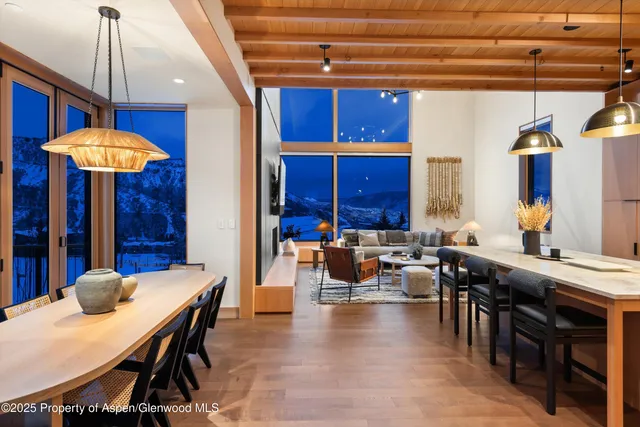 a view of a dining room with furniture and chandelier
