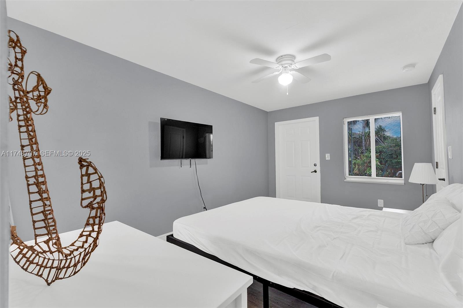 1120 Southwest 30th Street, Unit A Fort Lauderdale, FL 33315 - Photo 11 of 29 a bedroom with a bed and a flat screen tv
