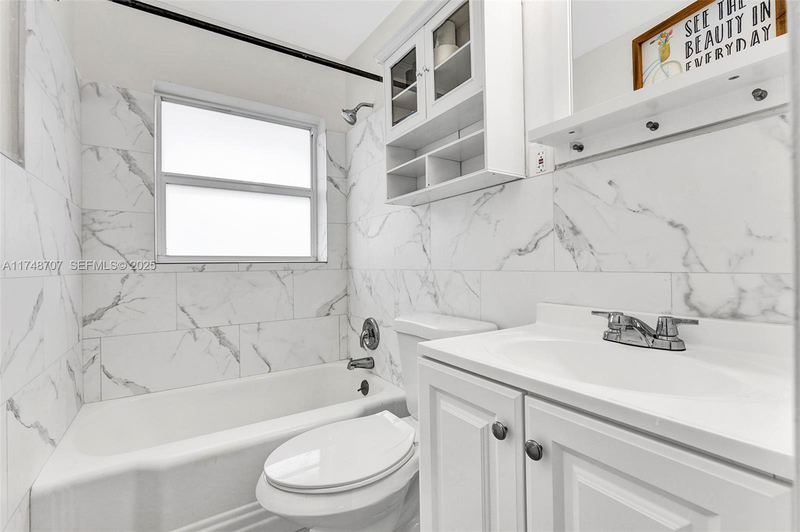 1120 Southwest 30th Street, Unit A Fort Lauderdale, FL 33315 - Photo 12 of 29 a bathroom with a sink a toilet and a bathtub